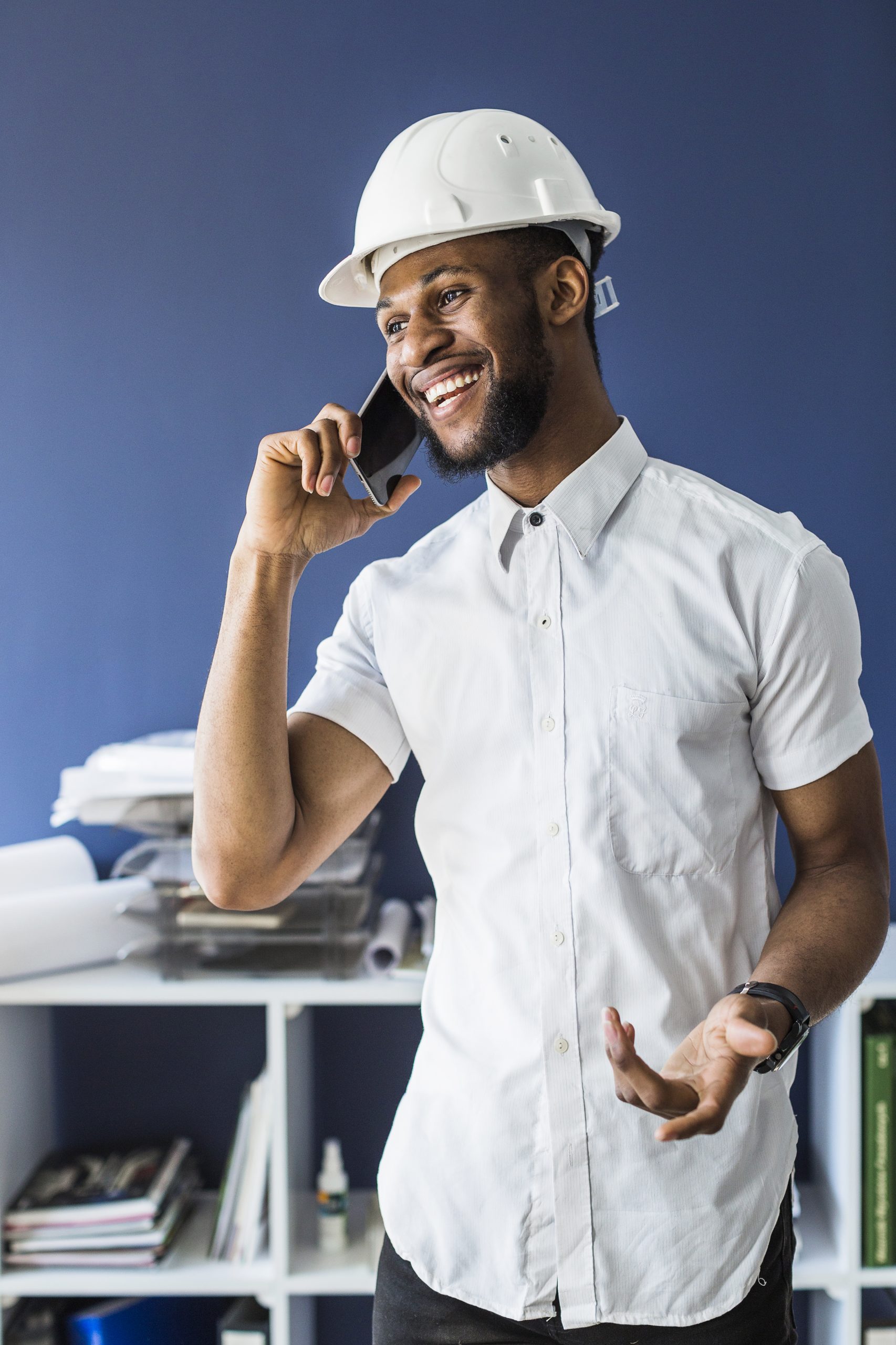 smiling african architect talking mobile phone office